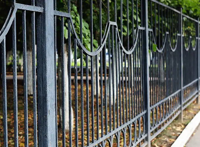 Iron fence with a decorative pattern installed on the outside of a Springfield IL park